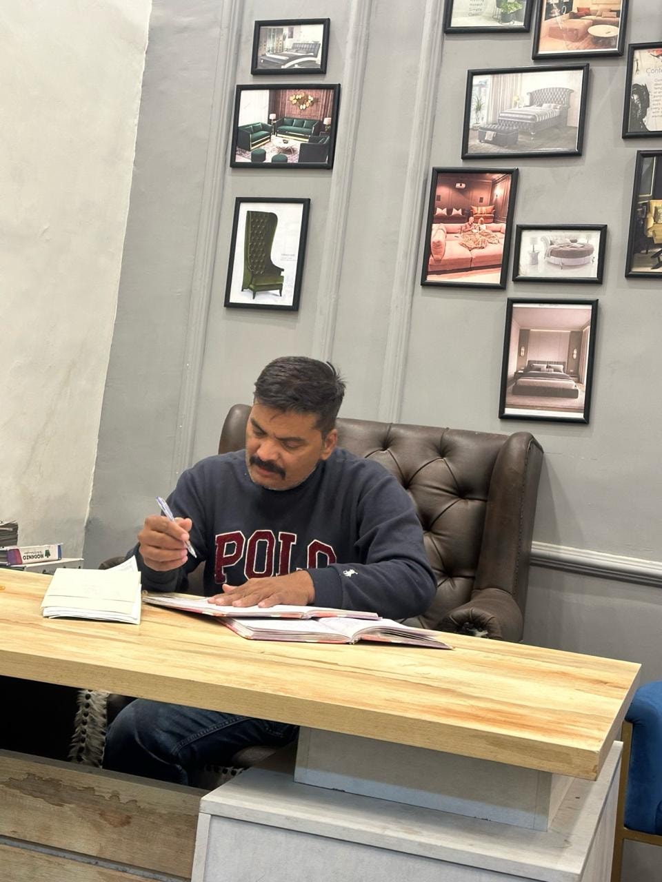 Ather Hussain — Founder of Sofa Concept, at his design desk in Karachi